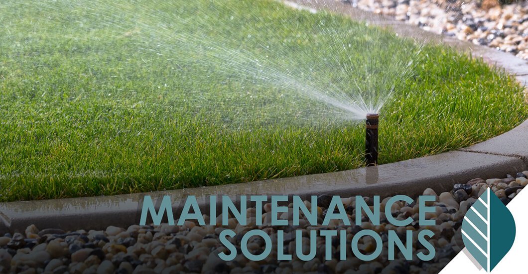 Maintenance Solutions text overlaid on photo of grass yard with sprinkler spraying water